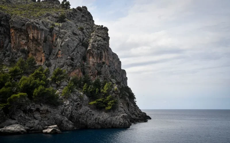 Majestic cliffs meet the Mediterranean in this scenic view of Mallorca, Spain.