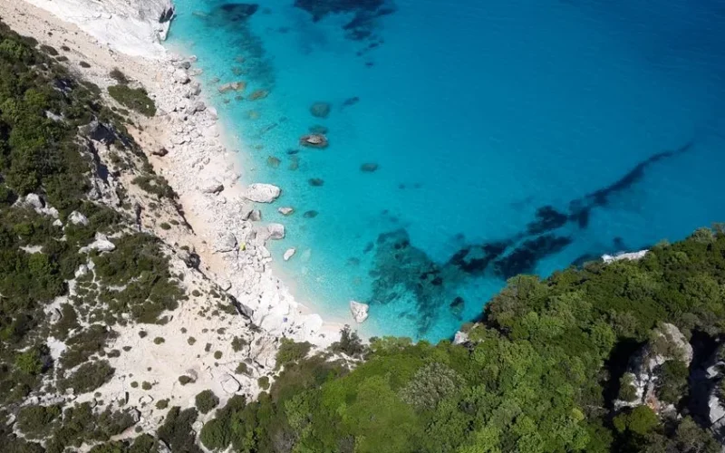 Stunning aerial shot of Cala Goloritzé, Sardinia with turquoise waters and rocky coastline.