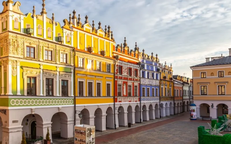 Vibrant Renaissance facades and arches in Zamość's historic market square, Poland.