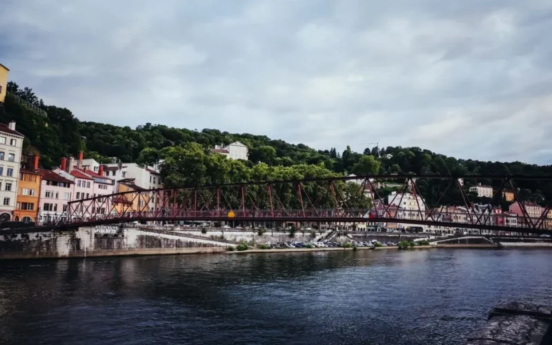 Picturesque view of a historic footbridge over the Saône River in Lyon, France.