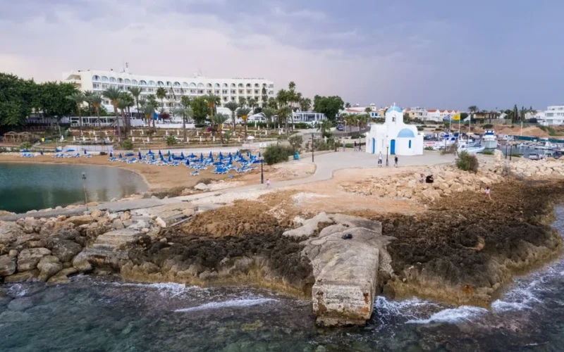 Aerial view of a church near the beach in Pernera, Cyprus, capturing the serene coastal landscape.