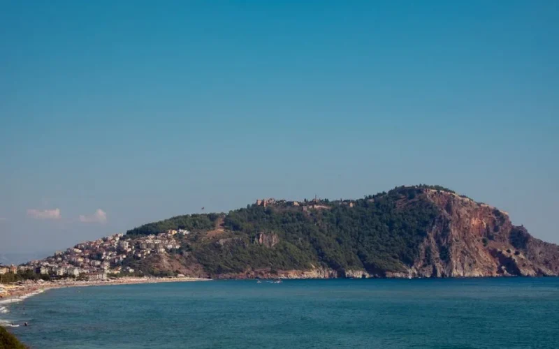 A breathtaking view of the Alanya Peninsula with clear blue skies and turquoise waters.
