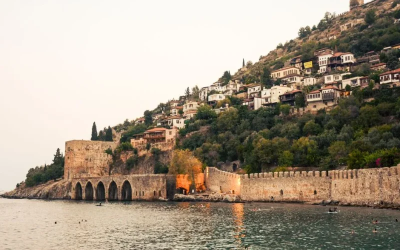 Alanya Castle overlooking the serene Mediterranean Sea at sunset, capturing timeless architecture.