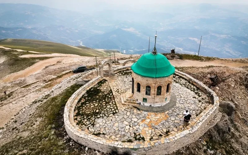 A breathtaking aerial view of a historic shrine on a mountain in Albania, showcasing stunning landscapes.