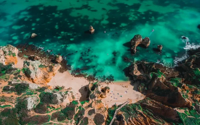 Explore the breathtaking Algarve coastline with its turquoise waters and stunning rock formations in Lagos, Portugal.