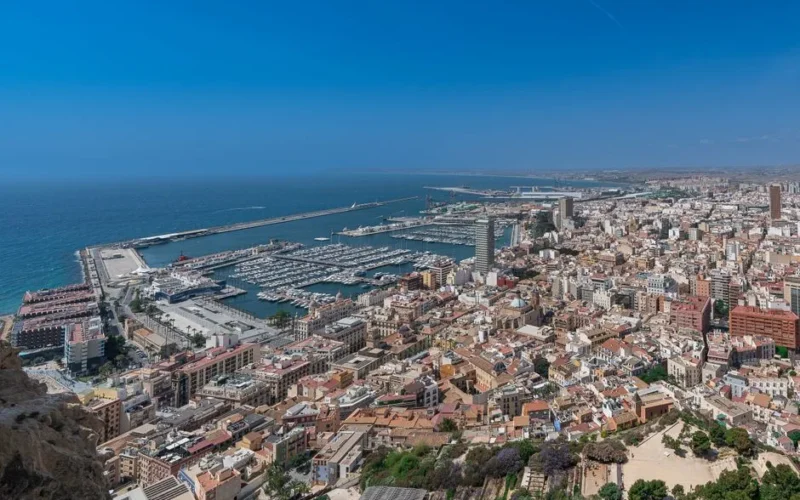 Stunning aerial view of Alicante's marina and cityscape under a clear blue sky.
