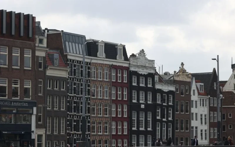 Quaint canal-side buildings in Amsterdam showcasing iconic Dutch architecture.