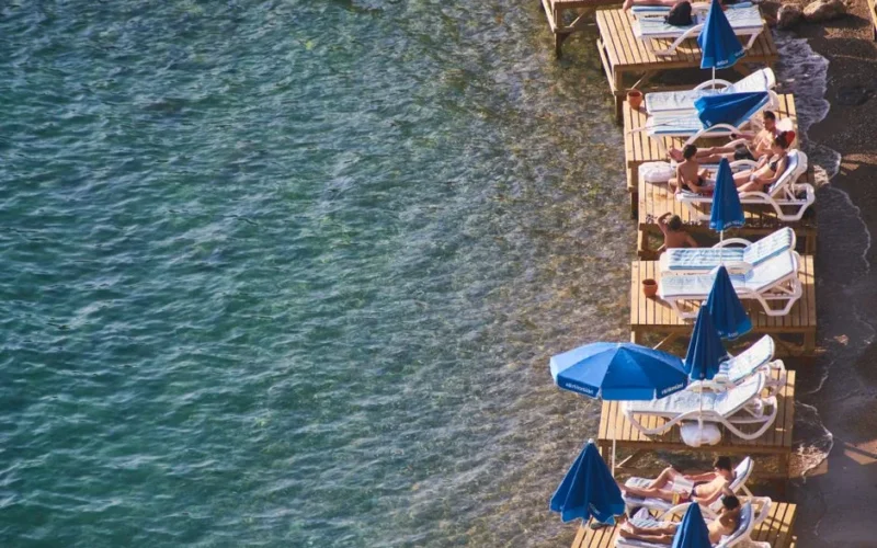 Relaxing on wooden platforms by the beach in Antalya, Turkey.