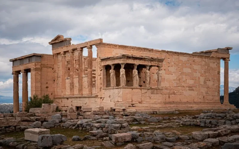 View of the ancient Erechtheion Temple with its iconic Caryatids, located at the Acropolis in Athens, Greece.