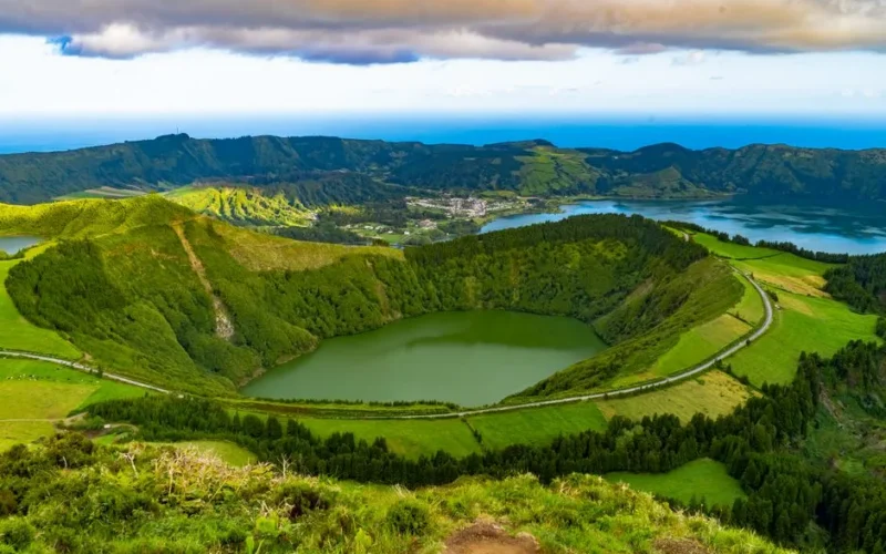 Explore the breathtaking view of lush green caldera landscapes in the Azores, Portugal with serene lakes and rolling hills.