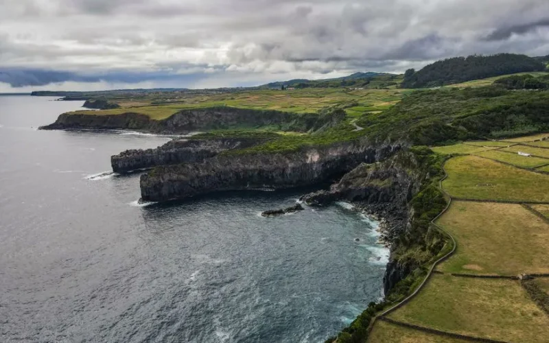 Aerial view of the dramatic coastal cliffs and lush landscapes of São Miguel Island, Azores.