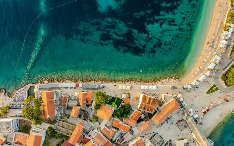 A breathtaking aerial view of Primošten, Croatia showcasing the vibrant coastline and clear waters.