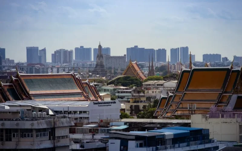 Skyline view of Bangkok highlighting traditional Thai architecture amidst modern buildings.