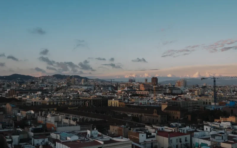 Stunning aerial view of Barcelona skyline during sunset, showcasing historic architecture.