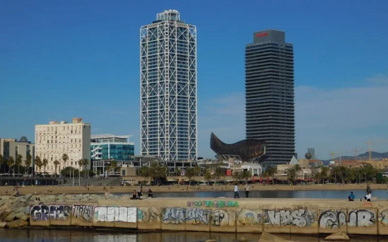 Stunning view of Barcelona's skyline featuring W Barcelona Hotel and Barceloneta Beach.