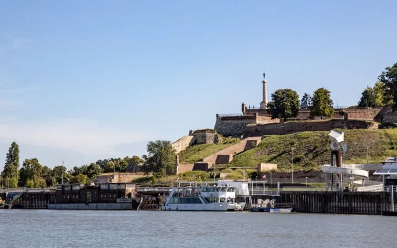 Scenic view of Belgrade Fortress overlooking the Sava River with boats docked.