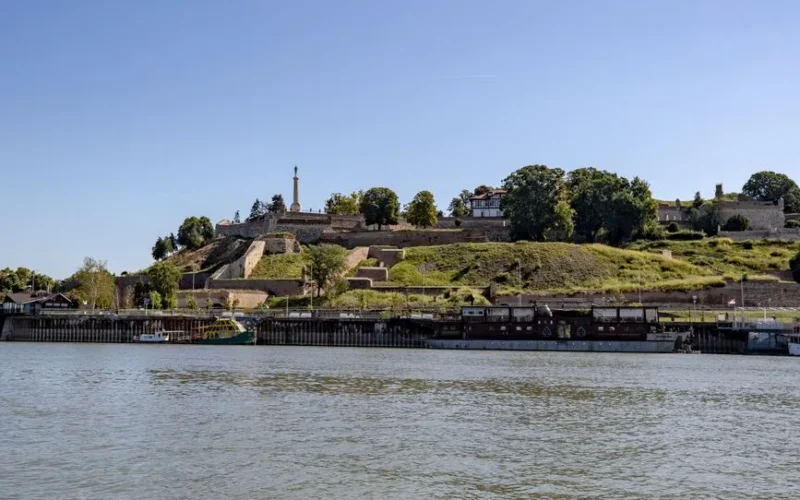 Scenic view of Belgrade Fortress and Sava River under a clear summer sky.