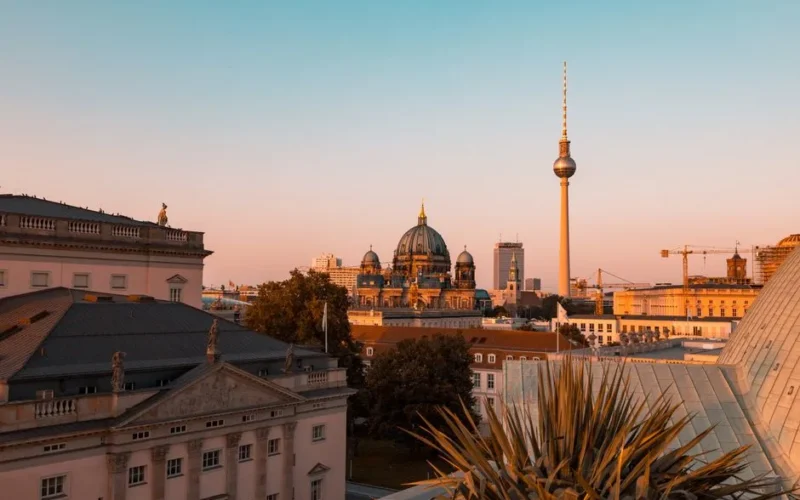A stunning view of Berlin's historic cityscape featuring the Berlin Cathedral and TV Tower at sunset.