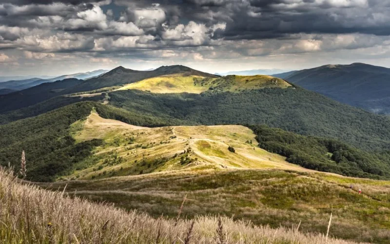 Breathtaking view of Bieszczady Mountains under a dramatic sky in Podkarpackie, Poland.
