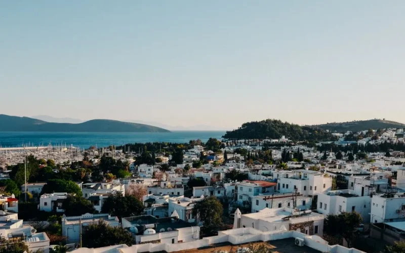 Explore the stunning coastal town of Bodrum, Turkey from above, showcasing its vibrant architecture and beautiful sea view.
