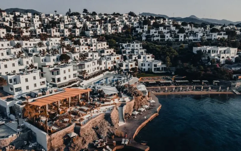 Breathtaking aerial drone shot of Bodrum's iconic whitewashed buildings along the stunning seashore.