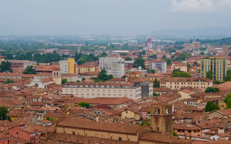Aerial shot of Bologna's historic cityscape with earthy tones and classic architecture.