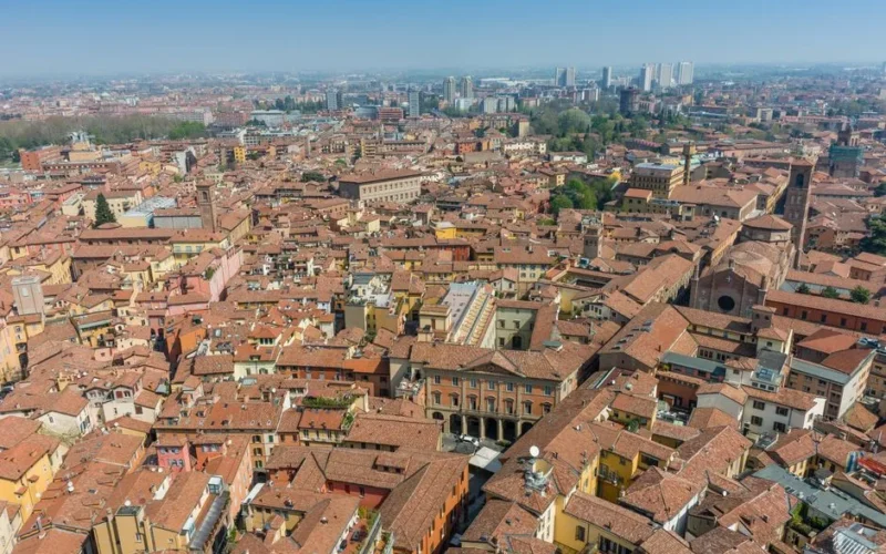 Aerial view showcasing the historic architecture and vibrant rooftops of Bologna, Italy.