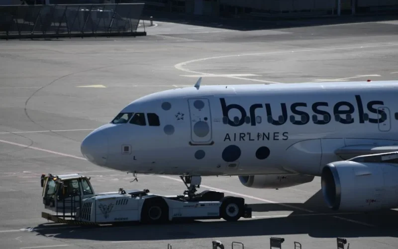 Brussels Airlines plane being towed on the runway at Geneva Airport, ready for takeoff.