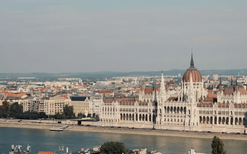 Scenic view of the iconic Hungarian Parliament Building along the Danube River in Budapest.