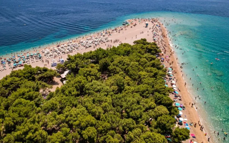 Stunning aerial view of the famous Zlatni Rat Beach with turquoise waters, ideal for summer vacations.