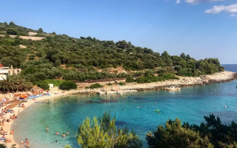 Scenic beach cove with clear turquoise waters at Vis Island, Croatia, perfect for a summer getaway.