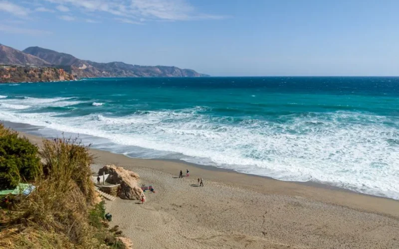 Stunning aerial view of Nerja Beach, Spain, featuring turquoise waters and scenic coastline.