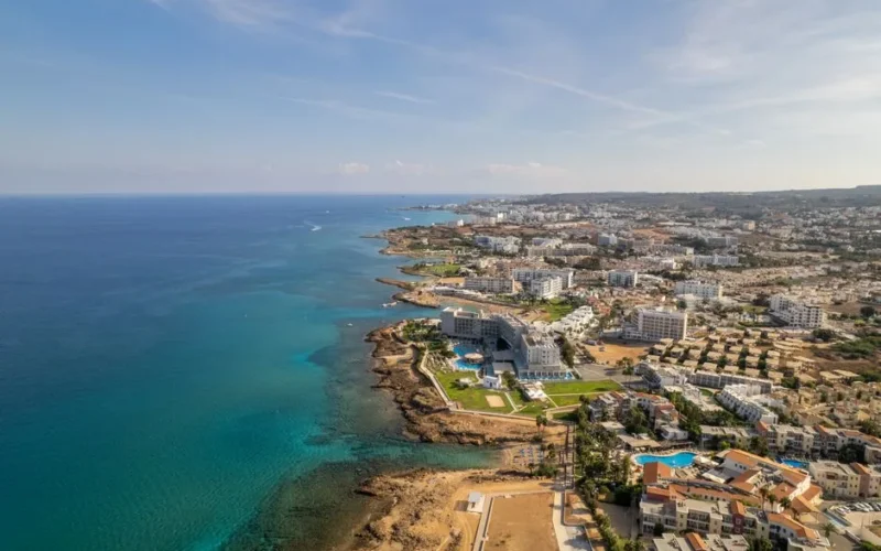 Stunning aerial view of Protaras coastline showcasing resorts, beaches, and crystal-clear waters in Cyprus.