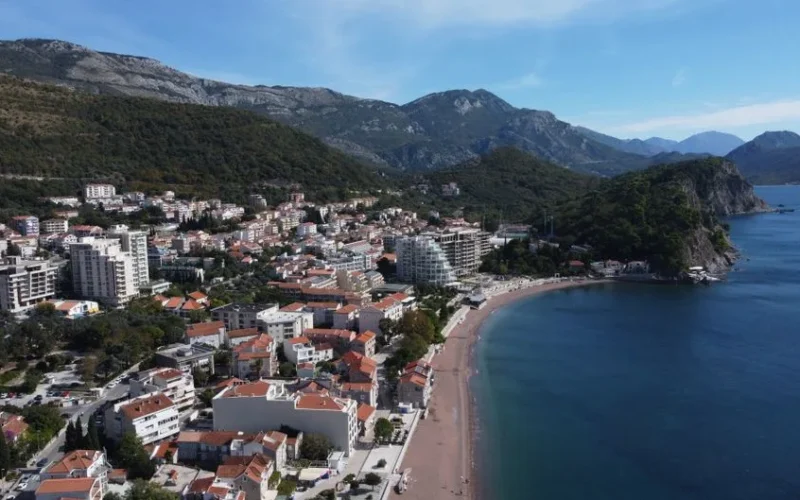 Stunning aerial view of Petrovac town and beach in Montenegro, showcasing coastal beauty.