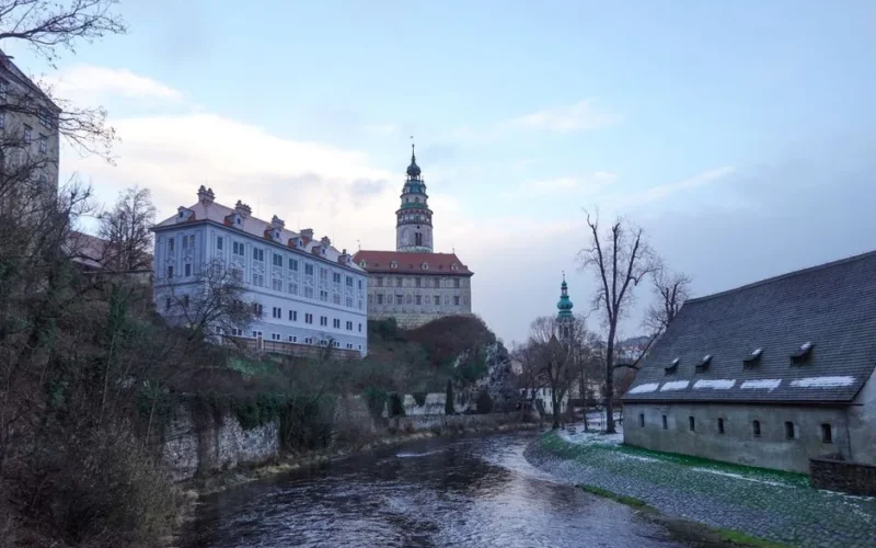 Scenic view of Český Krumlov Castle by the river during twilight in winter.
