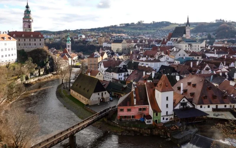Drone view of Český Krumlov in Czechia, showcasing its historic architecture and river landscape.