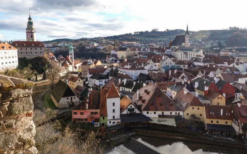 Stunning aerial view of Český Krumlov featuring the iconic castle and Saint Vitus Church set against charming urbanscape.