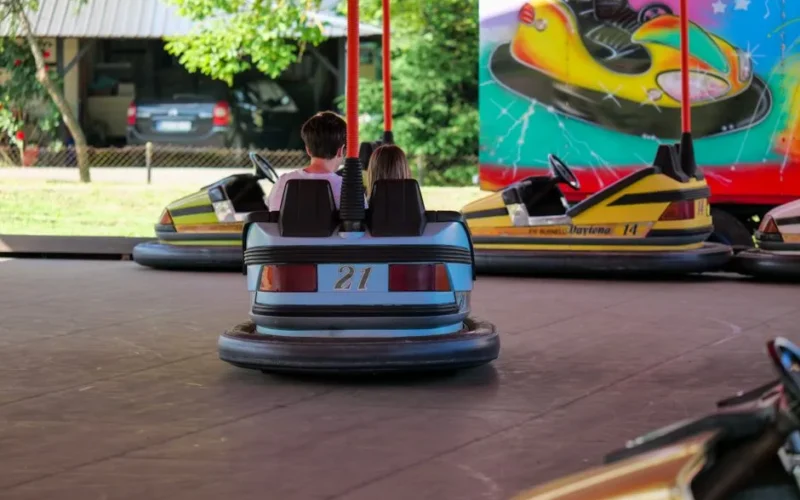 Kids having fun on bumper cars at Garešnica fairground. Exciting entertainment activity outdoors.