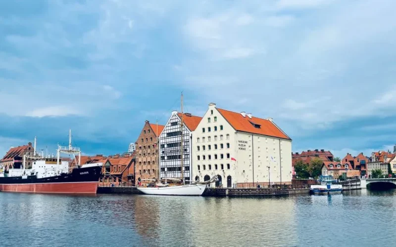 Beautiful view of Gdańsk Harbor featuring the National Maritime Museum and historic architecture.