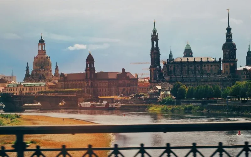 Picturesque cityscape of Dresden featuring historic architecture along the river's edge.