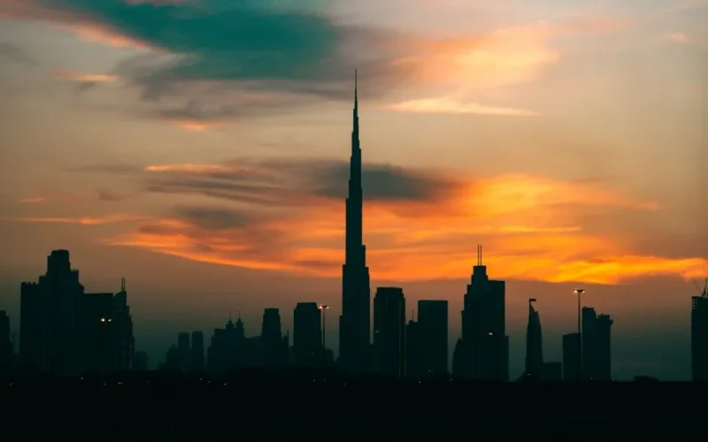 Silhouette of Dubai's skyline with Burj Khalifa at sunset, creating a stunning cityscape.