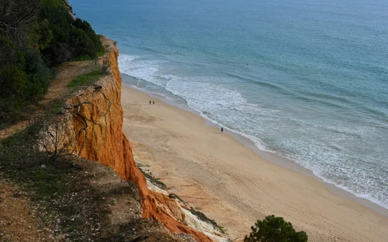 Dramatic cliffs overlooking the beautiful beaches of Faro, Portugal.