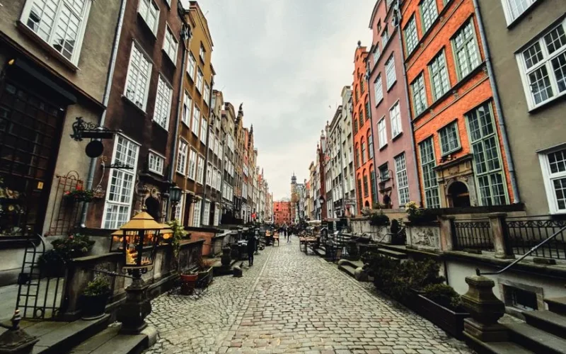 Picturesque view of historic Mariacka Street in Gdańsk, Poland, lined with colorful buildings.