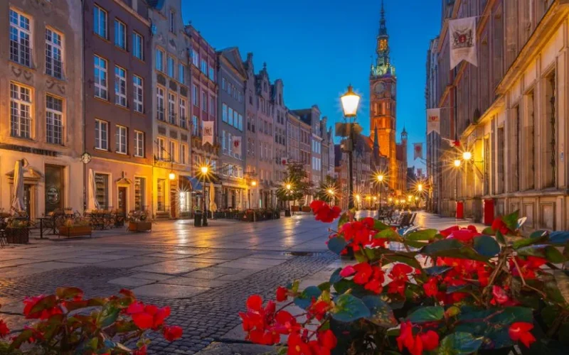 Charming evening view of Long Market, Gdańsk. Iconic architecture under blue sky.