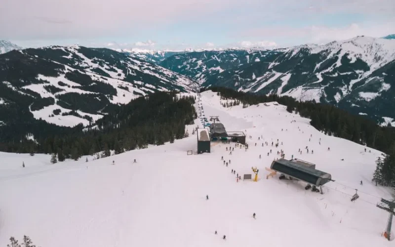Breathtaking aerial shot of a snowy ski resort in the Austrian Alps, ideal for winter sports enthusiasts.