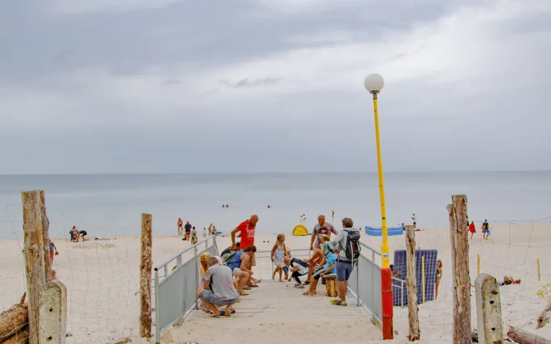 Relaxed beach atmosphere with people enjoying summer at Świętouść, Poland.