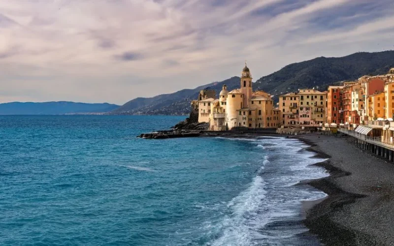 Scenic view of Camogli's vibrant buildings and coastline in Liguria, Italy.