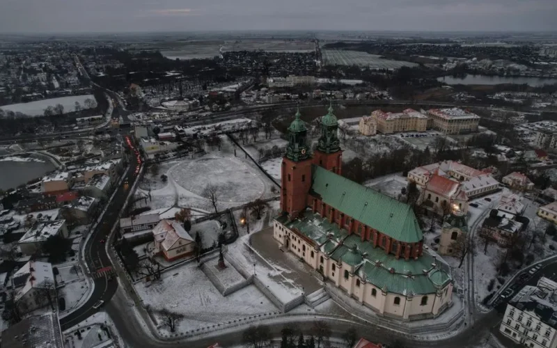A stunning aerial photo of Gniezno Cathedral covered in snow during winter in Poland.