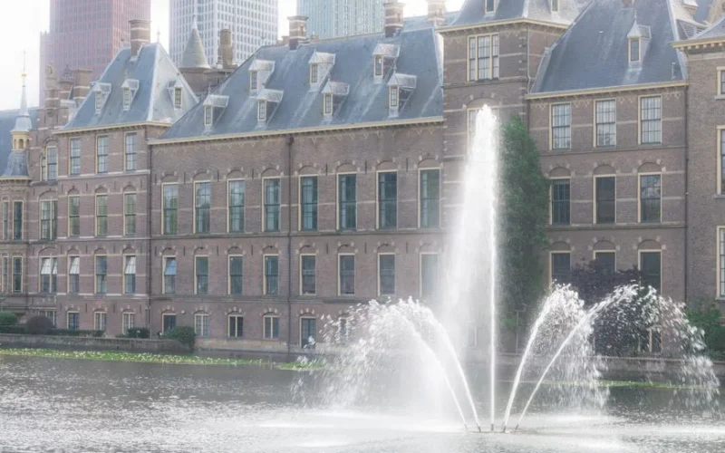 Scenic view of the Binnenhof government complex and water fountain in The Hague, Netherlands.