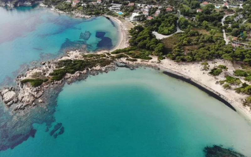 Discover the stunning beaches and vibrant sea of Sithonia, Halkidiki, Greece from above.